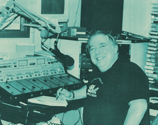 David Gibson at a recording console smiling